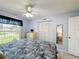Bedroom featuring a window, ceiling fan, and ample closet space at 716 Maderia Ct, Kissimmee, FL 34758