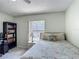 Comfortable bedroom featuring a twin bed, a ceiling fan, and a window view of the pool area at 716 Maderia Ct, Kissimmee, FL 34758
