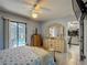 Comfortable bedroom featuring sliding glass door access to the pool area, dresser and tile floors at 716 Maderia Ct, Kissimmee, FL 34758