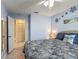 Relaxing blue bedroom with ceiling fan and access to a hallway with closet and bathroom at 716 Maderia Ct, Kissimmee, FL 34758