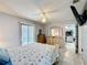 This bedroom boasts tile flooring, a ceiling fan, and sliding glass doors to a pool area at 716 Maderia Ct, Kissimmee, FL 34758