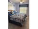Bedroom with rattan headboard and a stylish blue patterned comforter at 716 Maderia Ct, Kissimmee, FL 34758