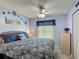 Inviting bedroom with calming blue walls, a ceiling fan, and a decorative beach themed wall art at 716 Maderia Ct, Kissimmee, FL 34758