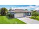 Well-maintained home featuring a clean two-car garage and solar panels at 716 Maderia Ct, Kissimmee, FL 34758