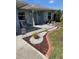 Inviting front porch with decor, seating, and colorful landscaping at 716 Maderia Ct, Kissimmee, FL 34758