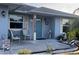 Inviting front porch with decor, seating, and a turquoise front door at 716 Maderia Ct, Kissimmee, FL 34758