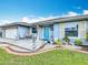 Single-story home showcasing a well-kept lawn, inviting front porch with chairs, and charming landscaping at 716 Maderia Ct, Kissimmee, FL 34758