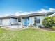 Charming single-story home with a well-maintained lawn, front porch seating, and tasteful landscaping at 716 Maderia Ct, Kissimmee, FL 34758