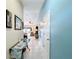 Hallway featuring tile floors, blue accent wall, and stylish decor leading to the living areas at 716 Maderia Ct, Kissimmee, FL 34758