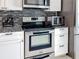 Modern kitchen features stainless steel oven, glasstop range, microwave and countertop oven at 716 Maderia Ct, Kissimmee, FL 34758