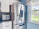 Updated kitchen boasts stainless steel refrigerator and granite countertops at 716 Maderia Ct, Kissimmee, FL 34758