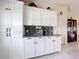 Bright and spacious kitchen with modern appliances, granite counters, and white cabinetry at 716 Maderia Ct, Kissimmee, FL 34758