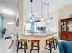 Modern kitchen with granite countertops, breakfast bar, and stainless steel appliances at 716 Maderia Ct, Kissimmee, FL 34758