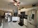 Open concept kitchen with granite countertops, stainless steel appliances, and tile floors at 716 Maderia Ct, Kissimmee, FL 34758