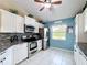 Updated kitchen with stainless steel appliances, granite countertops, and white cabinetry at 716 Maderia Ct, Kissimmee, FL 34758