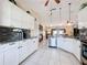 Spacious open concept kitchen with white cabinets, granite countertops, and stainless steel appliances at 716 Maderia Ct, Kissimmee, FL 34758