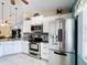 Modern kitchen features stainless steel appliances, granite counters and stylish backsplash at 716 Maderia Ct, Kissimmee, FL 34758