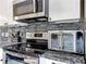 Close up of kitchen appliances: stainless steel oven, glasstop range, microwave and countertop oven at 716 Maderia Ct, Kissimmee, FL 34758