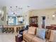 Open living room with barstool seating to the kitchen, adjacent dining area, and living area at 716 Maderia Ct, Kissimmee, FL 34758