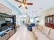 Living space with tiled floors opening into the kitchen and dining area at 716 Maderia Ct, Kissimmee, FL 34758