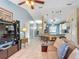 Spacious living room with kitchen view, stylish lighting, and comfortable seating arrangement at 716 Maderia Ct, Kissimmee, FL 34758