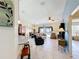 Open-concept living room with tile floors, ceiling fan, and view of the pool area at 716 Maderia Ct, Kissimmee, FL 34758