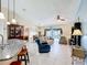 Spacious living room featuring tile floors, comfortable seating, and view of the pool at 716 Maderia Ct, Kissimmee, FL 34758