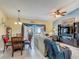 Open-concept living area with dining area and a view of the outdoor pool area through sliding glass doors at 716 Maderia Ct, Kissimmee, FL 34758