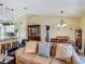 Living room showcases an open floor plan with kitchen, dining, and comfortable seating at 716 Maderia Ct, Kissimmee, FL 34758