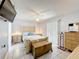 Charming bedroom featuring a ceiling fan, neutral colors, and a view of the backyard through the window at 716 Maderia Ct, Kissimmee, FL 34758