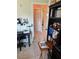 Functional office space with desk, shelving, and access to other rooms at 716 Maderia Ct, Kissimmee, FL 34758