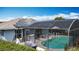 Screened-in pool with solar panels, lounge chairs, and outdoor dining area on the home's exterior at 716 Maderia Ct, Kissimmee, FL 34758