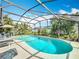 Beautiful screened-in pool area surrounded by lush landscaping and patio furniture at 716 Maderia Ct, Kissimmee, FL 34758