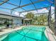 Enjoy the sun in the screened in pool area, complete with solar panels and views of the surrounding landscaping at 716 Maderia Ct, Kissimmee, FL 34758