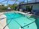 Sparkling pool surrounded by patio, grill, and seating in screened area at 716 Maderia Ct, Kissimmee, FL 34758
