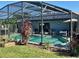 Screened pool with solar panels, outdoor seating and view of the house at 716 Maderia Ct, Kissimmee, FL 34758