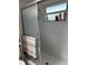 Enclosed shower with sliding glass door and a window with toiletries on the sill at 716 Maderia Ct, Kissimmee, FL 34758