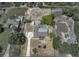 A tranquil aerial view shows a home with ample space and a large lot waiting for your personal touch at 9019 Oakwood Dr, Lake Wales, FL 33898
