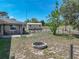 View of the expansive backyard, patio, storage shed, fire pit, and perimeter fencing at 9019 Oakwood Dr, Lake Wales, FL 33898