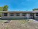Spacious backyard featuring a cozy patio, fire pit, and lush greenery at 9019 Oakwood Dr, Lake Wales, FL 33898
