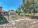 Large fenced-in backyard featuring lush greenery, a storage shed, and plenty of open space at 9019 Oakwood Dr, Lake Wales, FL 33898