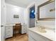 Hall bathroom with double vanity, make-up vanity, and tiled floors at 9019 Oakwood Dr, Lake Wales, FL 33898