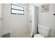 Bathroom with white tiled shower, black framed window, and modern shower head at 9019 Oakwood Dr, Lake Wales, FL 33898