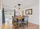 Well-lit dining room with tile flooring and contemporary pendant lights above a dining table at 9019 Oakwood Dr, Lake Wales, FL 33898