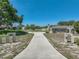 Expansive driveway leading to a well-maintained home with mature trees and lush greenery at 9019 Oakwood Dr, Lake Wales, FL 33898