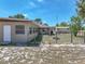 Spacious backyard with a covered patio, shed, fire pit, and fencing, perfect for outdoor living at 9019 Oakwood Dr, Lake Wales, FL 33898