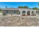 Charming single-story home featuring a covered patio with arched openings and a well-maintained front yard at 9019 Oakwood Dr, Lake Wales, FL 33898