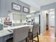 Well-lit kitchen featuring stainless steel appliances, grey cabinets and countertops and tile flooring at 9019 Oakwood Dr, Lake Wales, FL 33898
