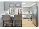 Well-lit kitchen featuring stainless steel appliances, grey cabinets and countertops and tile flooring at 9019 Oakwood Dr, Lake Wales, FL 33898