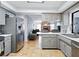 Well-lit kitchen featuring stainless steel appliances, grey cabinets and countertops and tile flooring at 9019 Oakwood Dr, Lake Wales, FL 33898